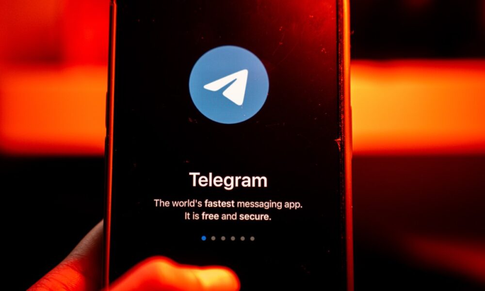 The logo for Telegram Signal messenger application arranged on a smartphone.