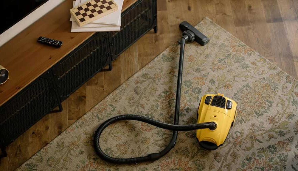 Yellow canister vacuum on a rug