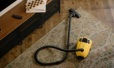 Yellow canister vacuum on a rug