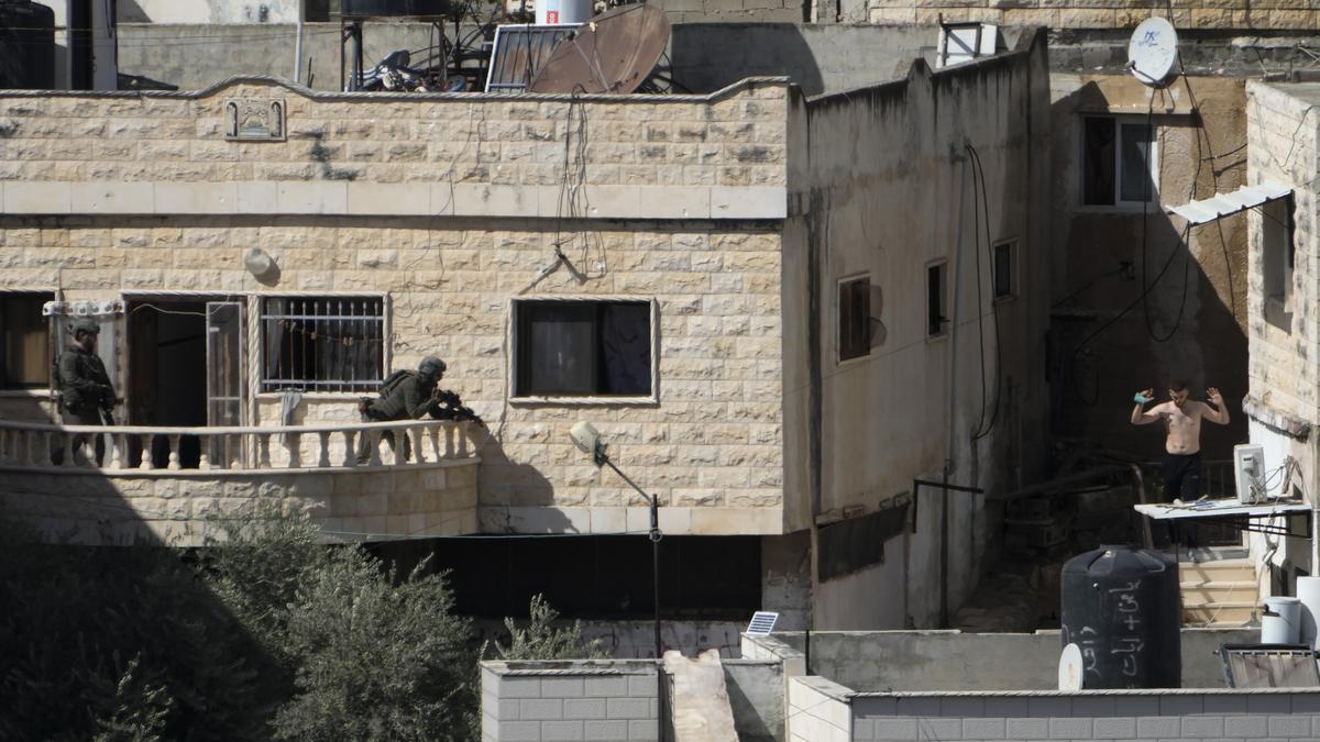 Israeli soldiers pushed three apparently lifeless bodies from roofs during a West Bank raid