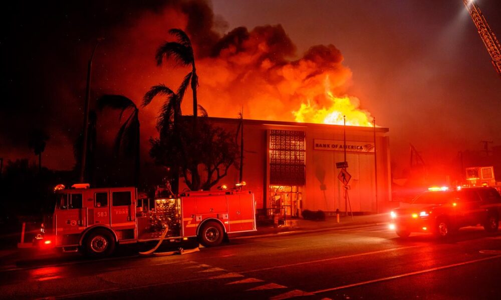 Firefighters battle devastating Los Angeles wildfires as winds calm somewhat