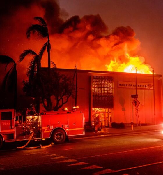 Firefighters battle devastating Los Angeles wildfires as winds calm somewhat