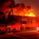 Firefighters battle devastating Los Angeles wildfires as winds calm somewhat