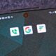 android phone with app logos Google, Google Voice, Google Fi