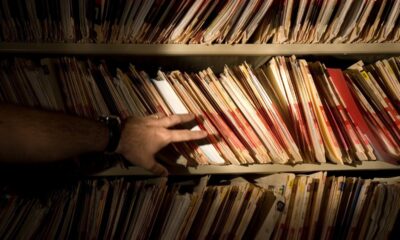 tons of medical records on a shelf in a darkened room