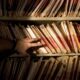 tons of medical records on a shelf in a darkened room