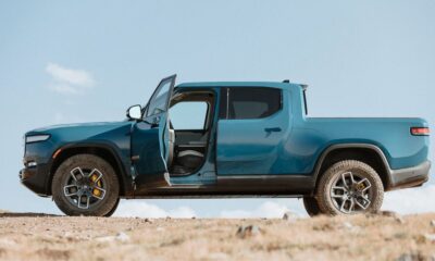 Blue Rivian R1T side view, driver door open