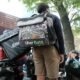 App-based delivery workers wait outside of a restaurant that uses app deliveries