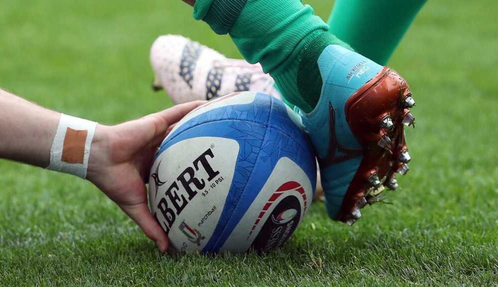 Rugby Ball being kicked by player