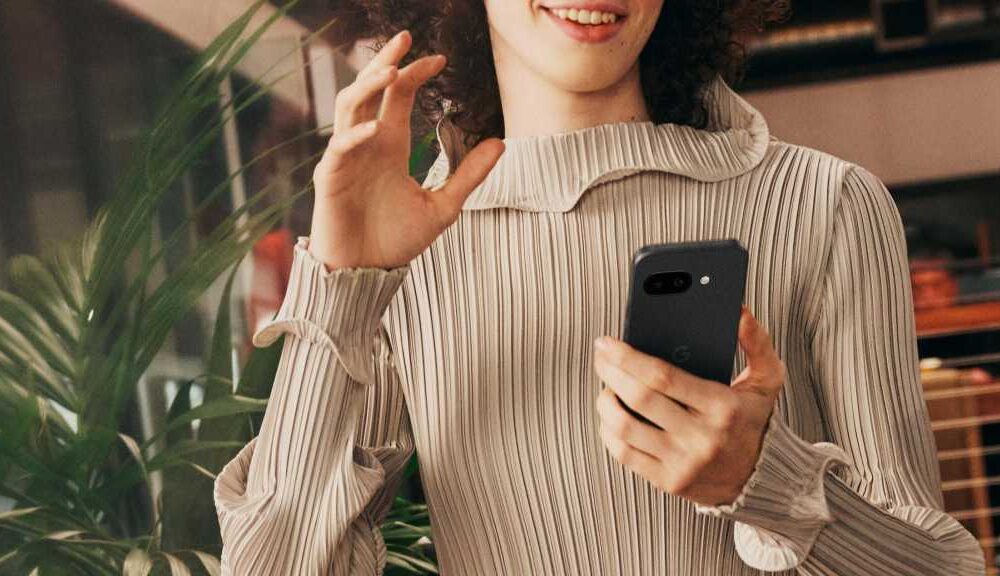 A woman holding the Google Pixel 9a