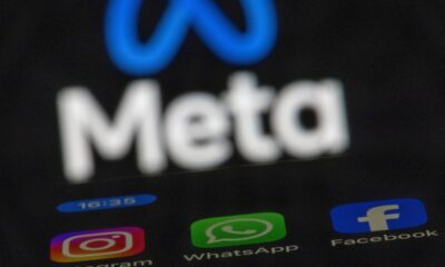 The apps Instagram, Facebook and WhatsApp can be seen on the display of a smartphone in front of the logo of the Meta internet company.