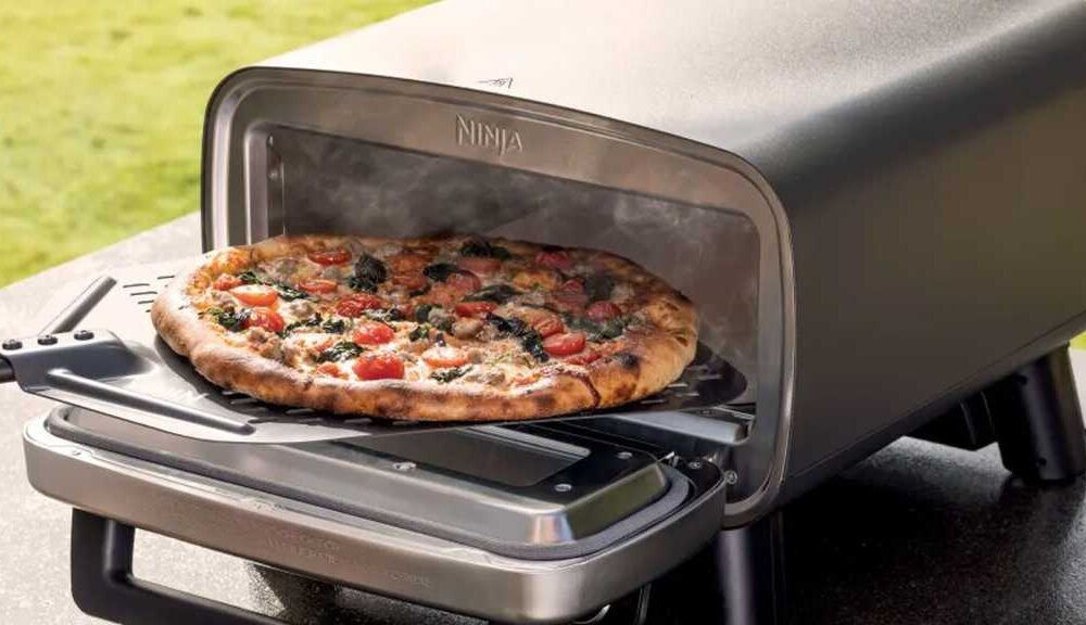 Pizza being removed from the Artisan oven