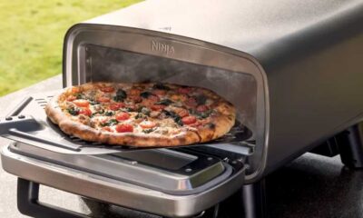 Pizza being removed from the Artisan oven