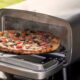 Pizza being removed from the Artisan oven