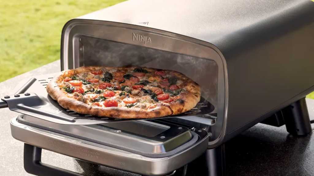 Pizza being removed from the Artisan oven