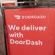 Sign reading We Deliver With Doordash, referencing the Doordash food delivery service, San Ramon, California, September 12, 2020. (Photo by Smith Collection/Gado/Getty Images)
