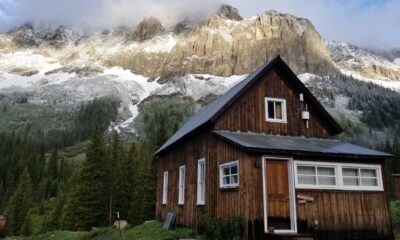 a brown building against mountain backdrop