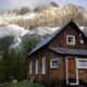 a brown building against mountain backdrop